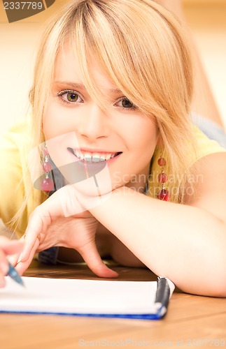 Image of teenage girl with notebook and pen