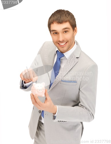 Image of handsome man with piggy bank