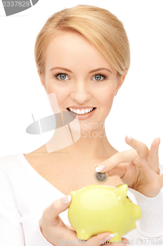 Image of lovely woman with piggy bank and money