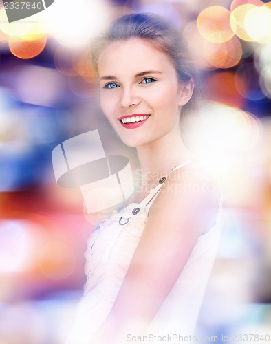 Image of happy and smiling teenage girl with city lights