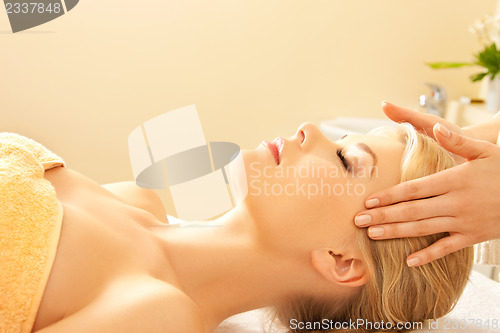 Image of beautiful woman in massage salon