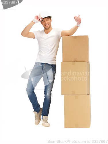 Image of handsome builder with big boxes