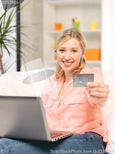 Image of happy woman with laptop computer and credit card