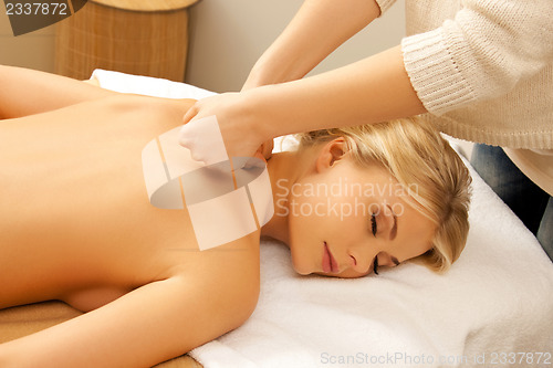 Image of beautiful woman in massage salon