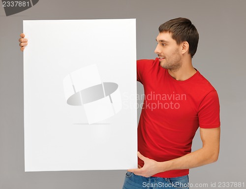 Image of handsome man with big blank board