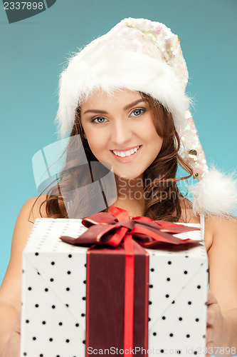 Image of cheerful santa helper girl with gift box