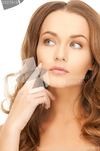 Image of beautiful woman pointing to cheek