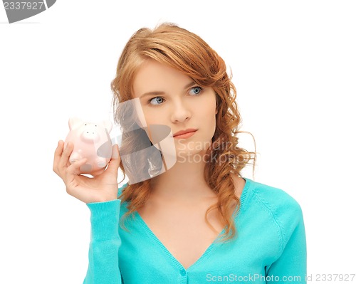 Image of teenage girl with piggy bank