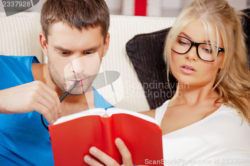 Image of couple at home with book