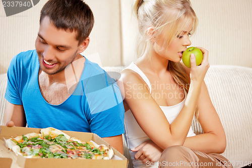 Image of couple eating different food