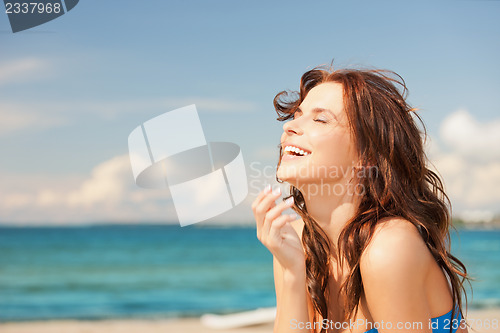 Image of laughing woman on the beach