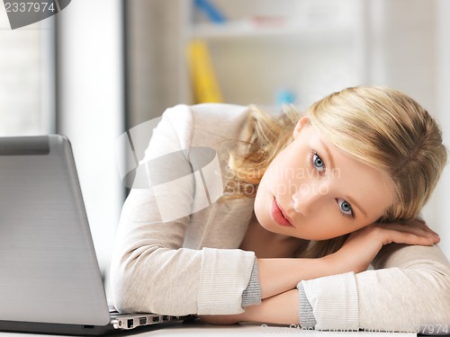 Image of tired woman with laptop computer