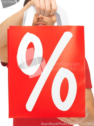 Image of man's hands holding shopping bag