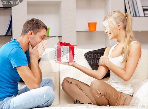 Image of happy romantic couple with gift