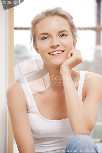 Image of happy teenage girl at the window