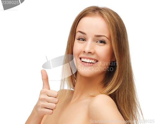 Image of beautiful woman showing thumbs up