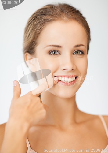 Image of beautiful woman pointing to teeth