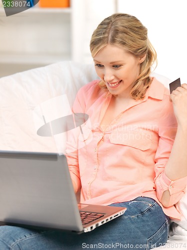 Image of happy woman with laptop computer and credit card