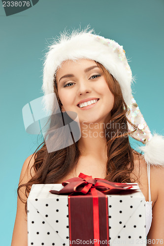 Image of cheerful santa helper girl with gift box