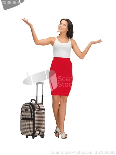 Image of happy woman with suitcase greeting
