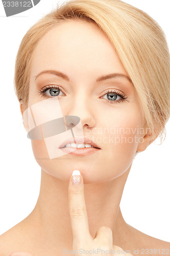 Image of beautiful woman pointing to chin