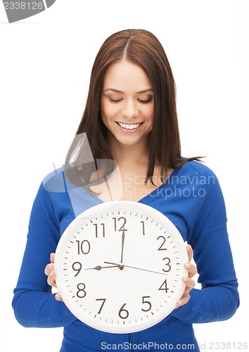 Image of woman holding big clock