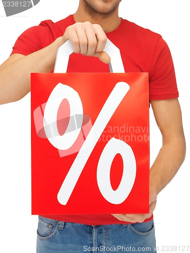 Image of man's hands holding shopping bag