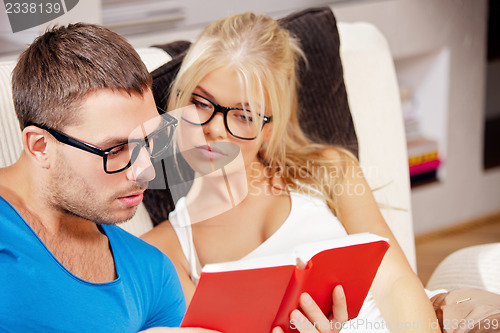 Image of couple at home with book