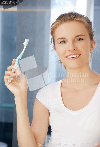 Image of smiling teenage girl with toothbrush