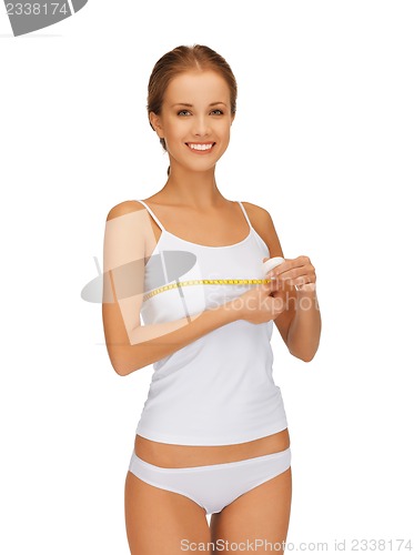 Image of woman measuring her breast