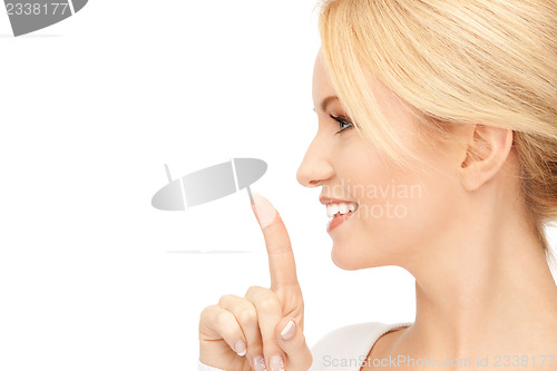 Image of happy woman with finger on lips