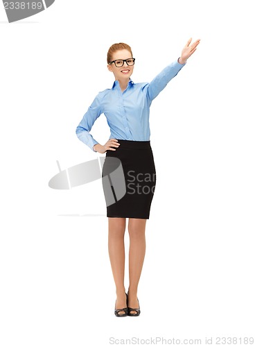 Image of attractive businesswoman pointing her hand