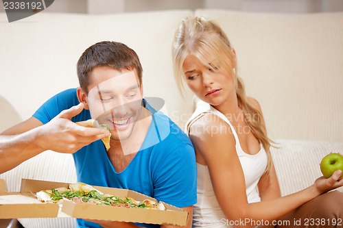 Image of couple eating different food