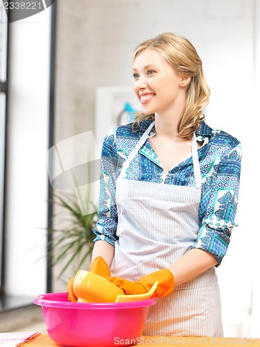 Image of housewife washing dish at the kitchen