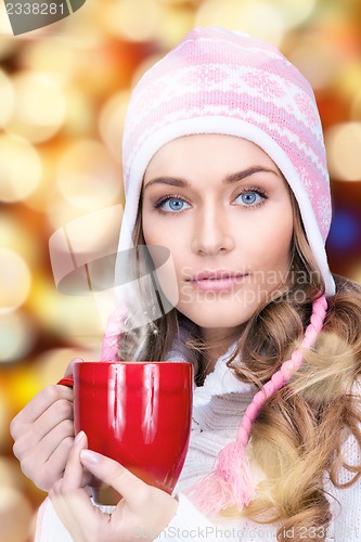 Image of beautiful woman with red mug