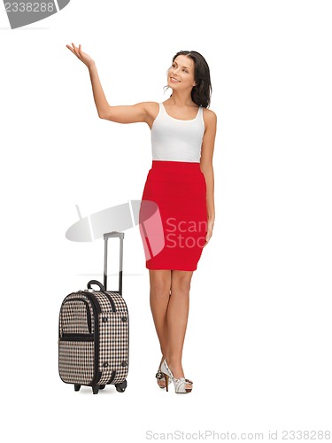 Image of happy woman with suitcase greeting