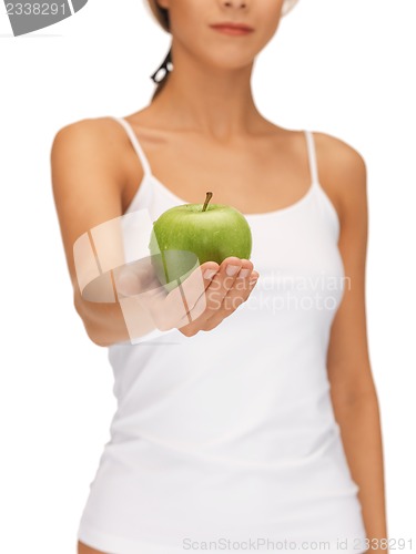 Image of female hands with green apple