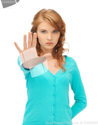 Image of young woman making stop gesture