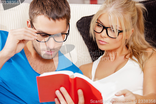 Image of couple at home with book