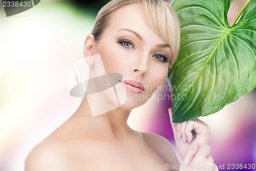 Image of woman with green leaf