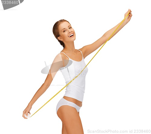 Image of young beautiful woman with measure tape