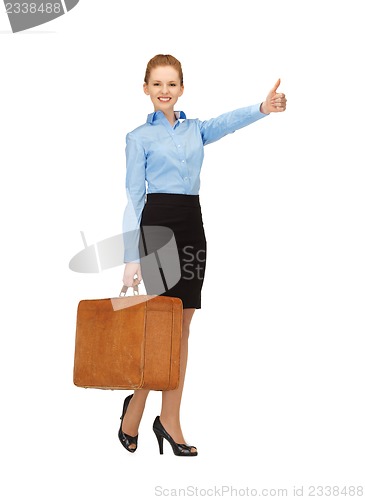 Image of hitch-hiking woman with suitcase