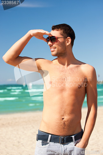 Image of happy smiling man on the beach