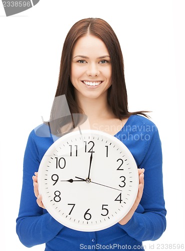 Image of woman holding big clock