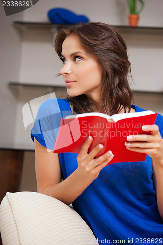 Image of calm and serious woman with book