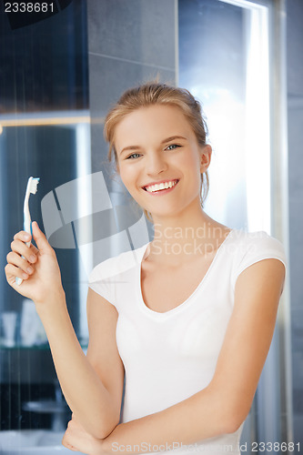 Image of smiling teenage girl with toothbrush