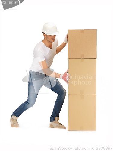 Image of handsome builder with big boxes