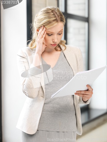 Image of worried woman with documents