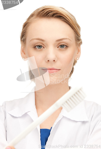 Image of attractive female doctor with toothbrush