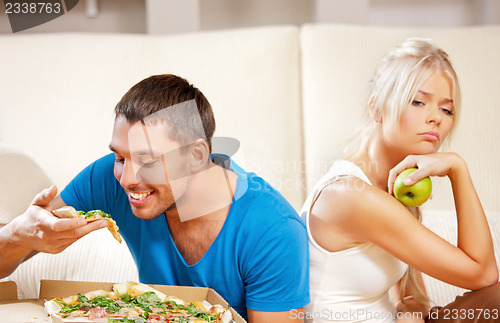 Image of couple eating different food